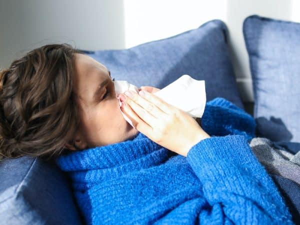 Woman in Blue Sweater Lying on Bed