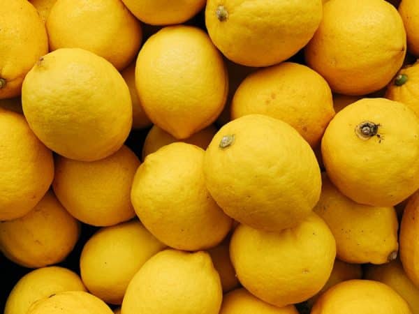 yellow citrus fruits on black surface